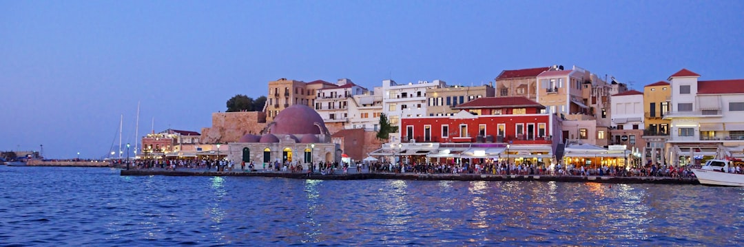 a harbor filled with lots of boats next to tall buildings