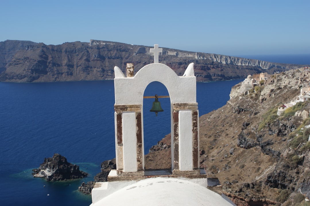 A bell tower with a bell on top of it