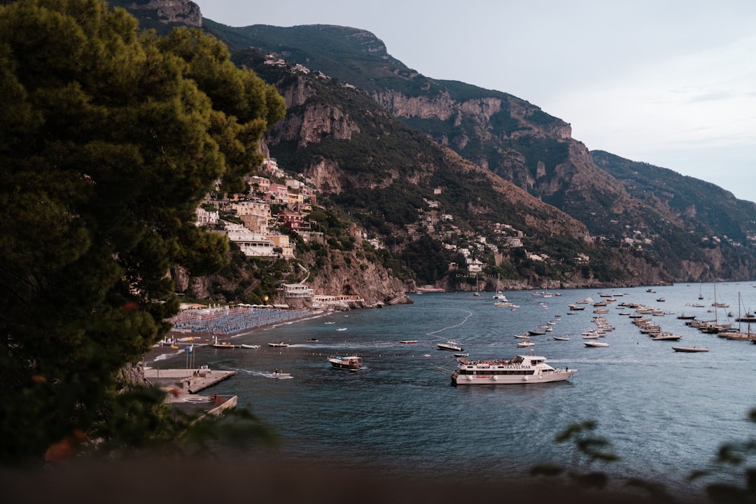 a group of boats floating on top of a body of water