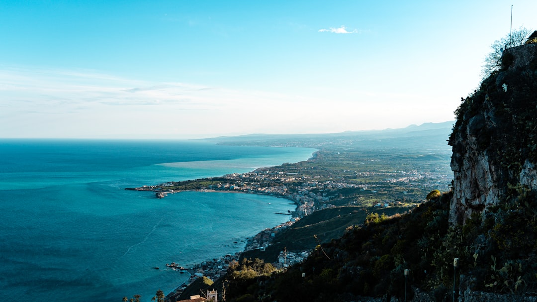 Coastal town nestled beside a calm blue sea.