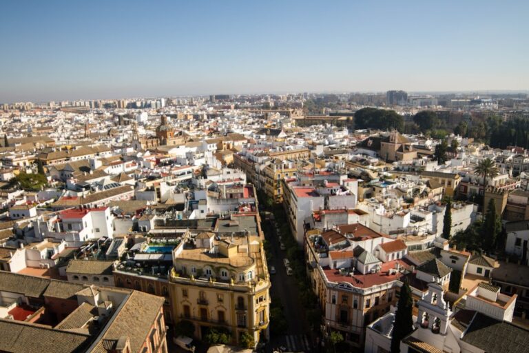 Aerial view of a dense european city with white buildings.