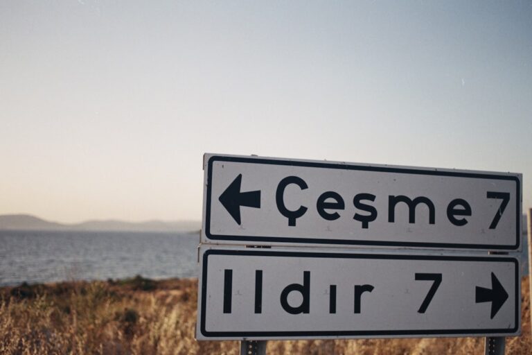 a road sign pointing to cesme and idr7