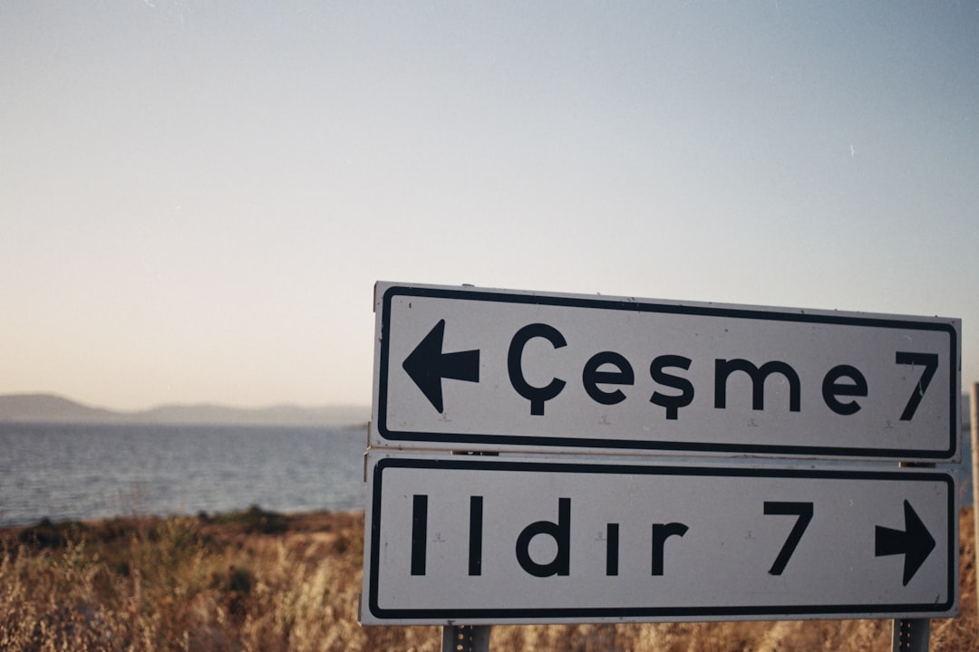 a road sign pointing to cesme and idr7