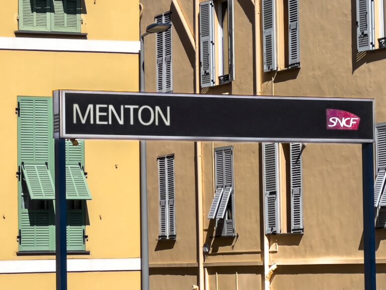 A street sign in front of a multi - colored building