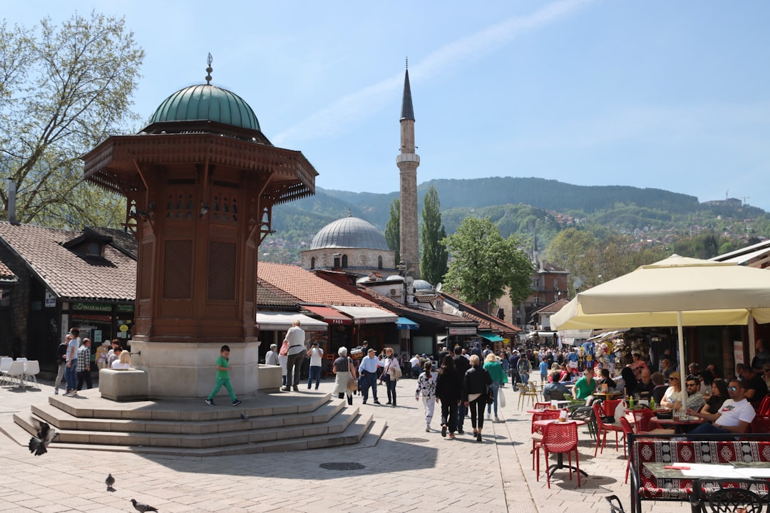 a group of people walking around a town square