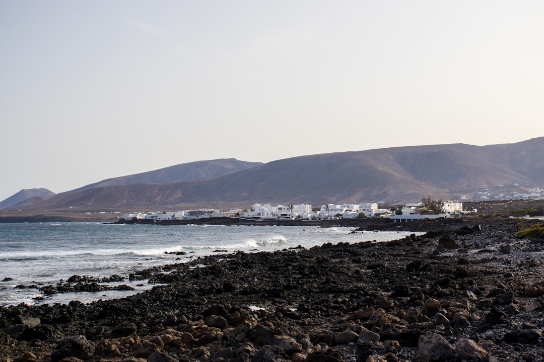 a rocky beach with a mountain in the background
