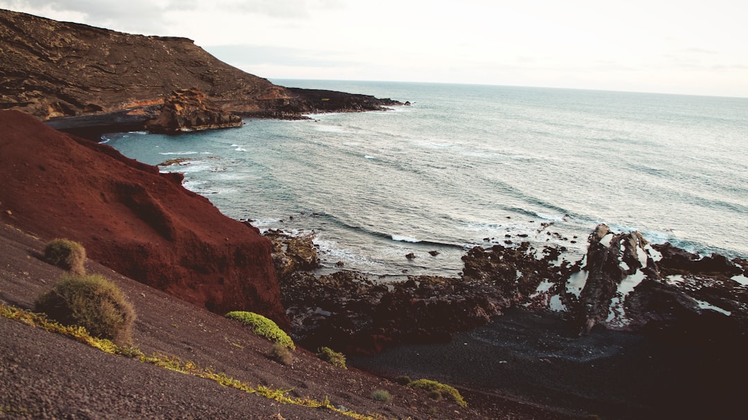 a view of the ocean from the top of a hill