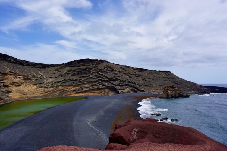 a beach with a rocky cliff