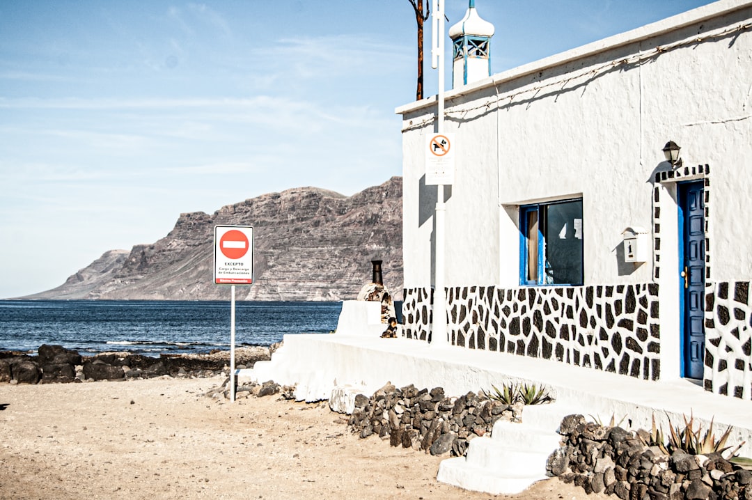 white concrete building near body of water during daytime