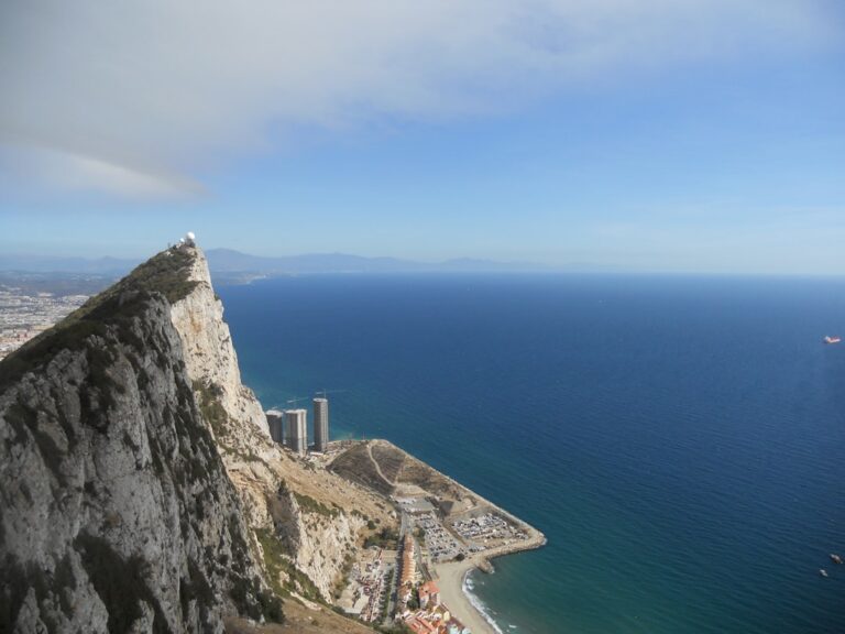 a city on a cliff by the ocean
