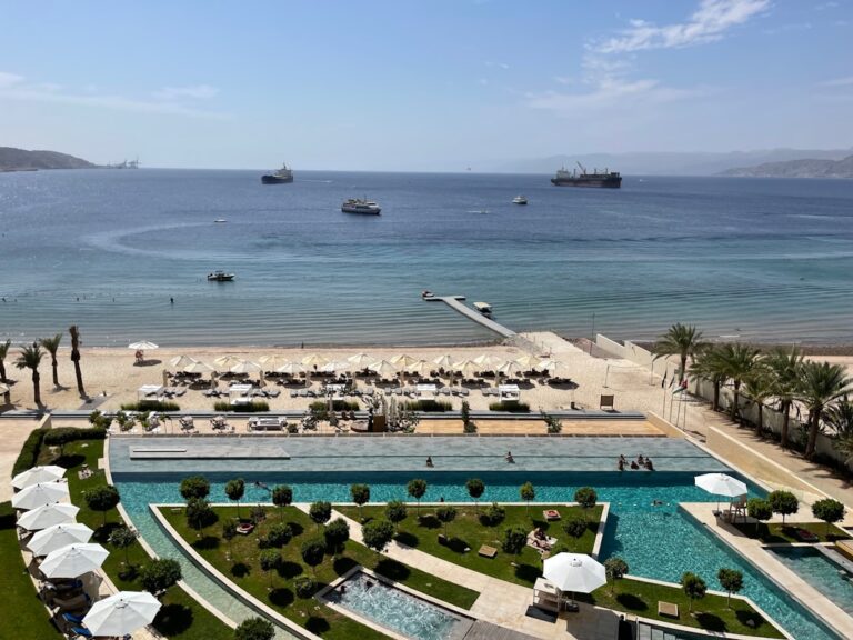 an aerial view of a beach and pool area