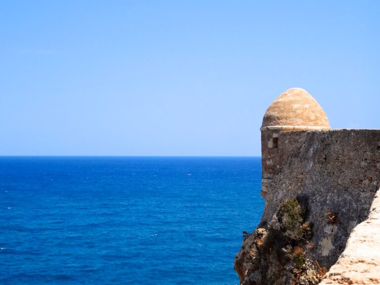 a stone structure on a cliff overlooking the ocean