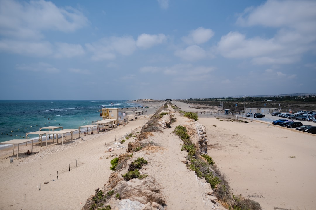a long stretch of sandy beach next to the ocean
