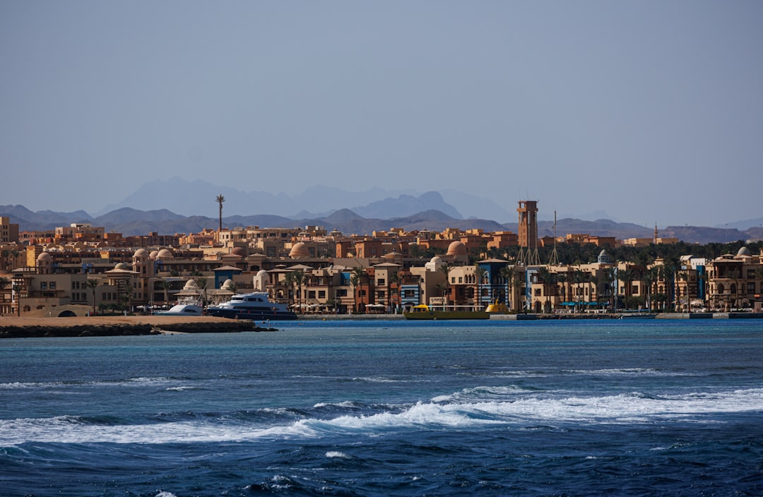 Coastal town with buildings and boats on the water.