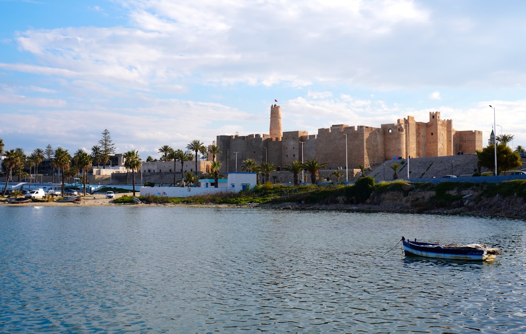 A coastal city with ancient architecture and a calm bay