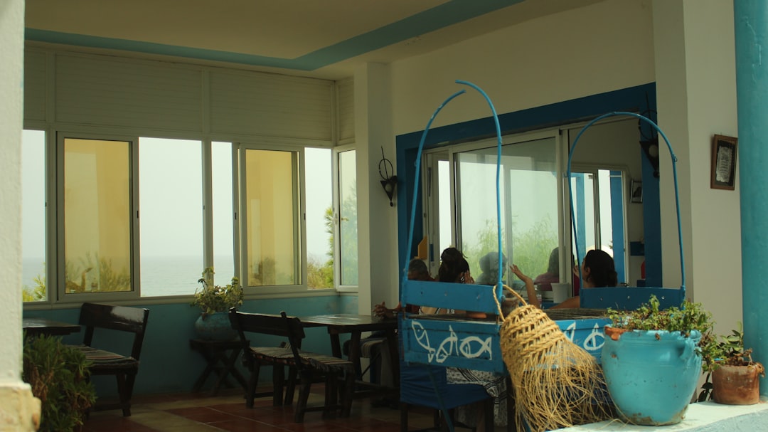 Open-air cafe with blue accents and sea view