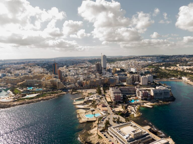 an aerial view of a city and a body of water