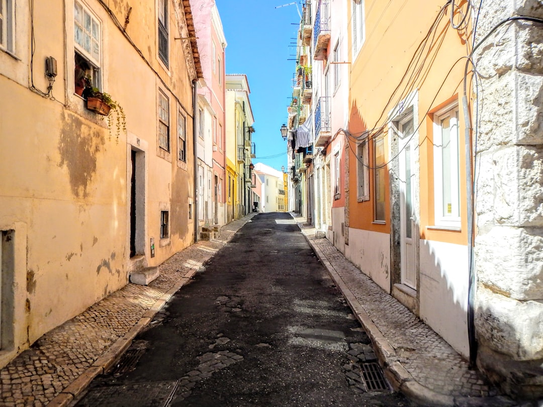 A narrow city street with buildings on both sides